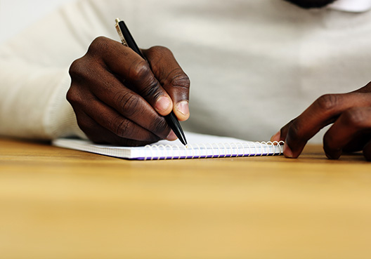Advanced Payment Bond man sitting behind desk signing document