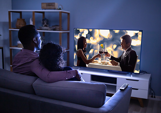 couple watching TV at night couple watching TV at night