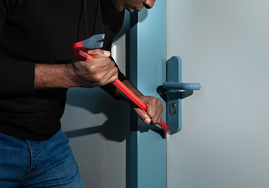 man breaking into a house