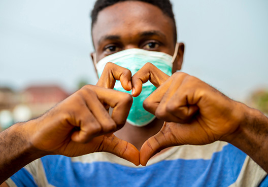man making a heart with his hands