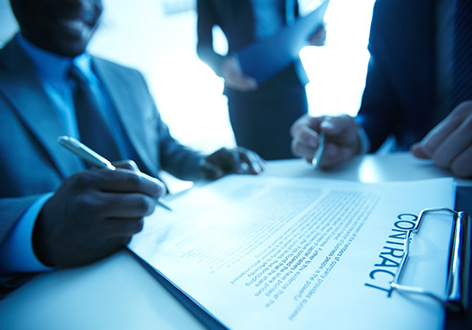 Advanced Payment Bond man sitting at desk signing a document