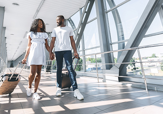 couple walking hand in hand at the airport couple walking hand in hand at the airport